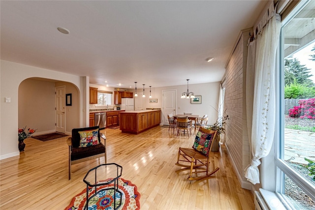141 Leslie Ln, Sequim, WA 98382 - living room with arched walkways, light wood-type flooring, recessed lighting, and a chandelier