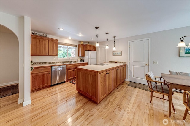 141 Leslie Ln, Sequim, WA 98382 - kitchen featuring stainless steel dishwasher, freestanding refrigerator, a peninsula, light wood-style floors, and recessed lighting