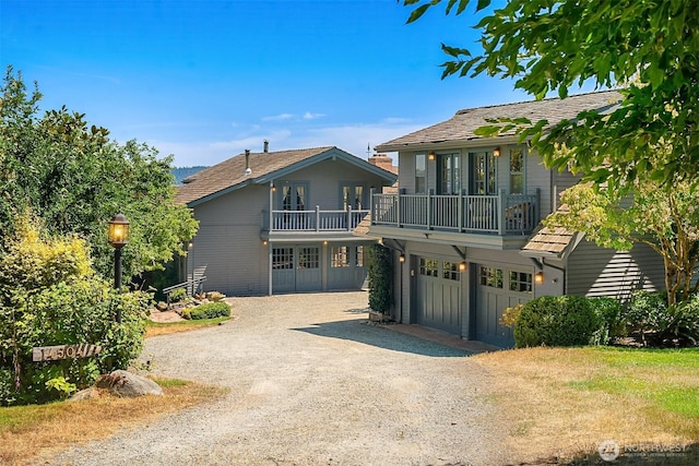 14504 Glen Acres Rd, Vashon, WA 98070 - view of front of property featuring a balcony, driveway, french doors, and a garage