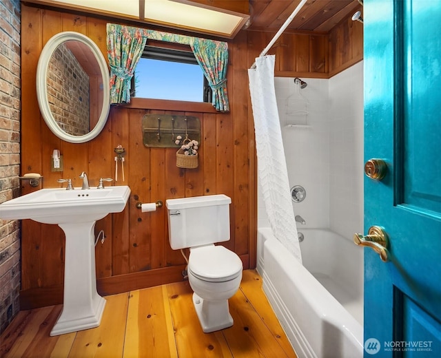 14504 Glen Acres Rd, Vashon, WA 98070 - bathroom featuring wood-type flooring, shower / tub combo with curtain, and wooden walls