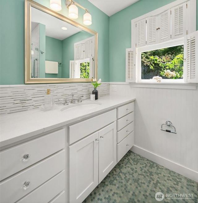 14504 Glen Acres Rd, Vashon, WA 98070 - full bathroom with vanity, tile patterned floors, a shower with shower door, decorative backsplash, and a wainscoted wall