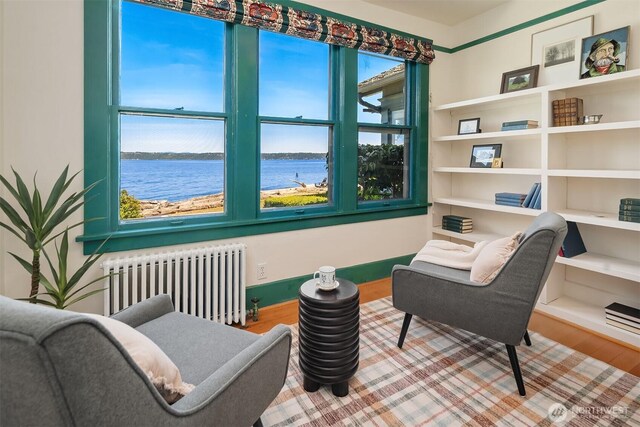 14504 Glen Acres Rd, Vashon, WA 98070 - sitting room with radiator, wood finished floors, and a water view