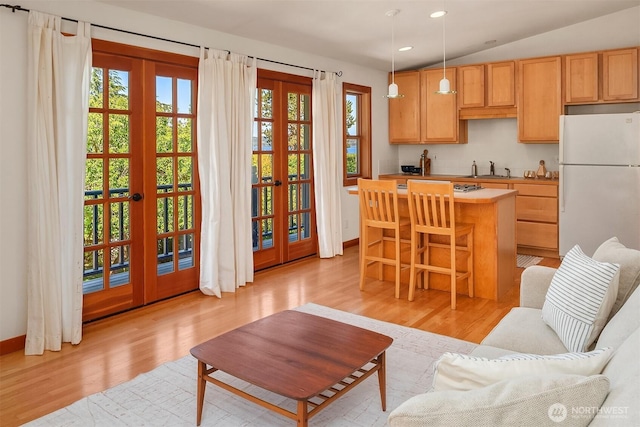14504 Glen Acres Rd, Vashon, WA 98070 - kitchen featuring freestanding refrigerator, french doors, light wood-style flooring, a center island, and healthy amount of natural light