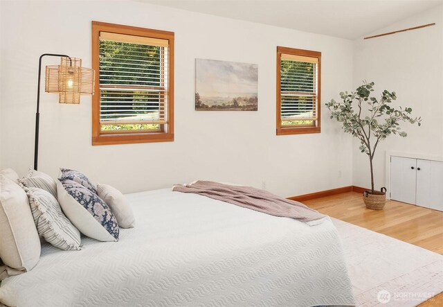 14504 Glen Acres Rd, Vashon, WA 98070 - bedroom featuring multiple windows, wood finished floors, and vaulted ceiling