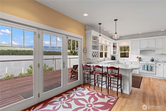 15320 Cedar Brae, Leavenworth, WA 98826 - kitchen with open shelves, white cabinetry, light countertops, a peninsula, and plenty of natural light