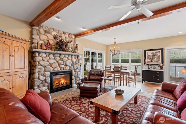 15320 Cedar Brae, Leavenworth, WA 98826 - living area featuring beamed ceiling, plenty of natural light, a stone fireplace, a chandelier, and light wood-style floors