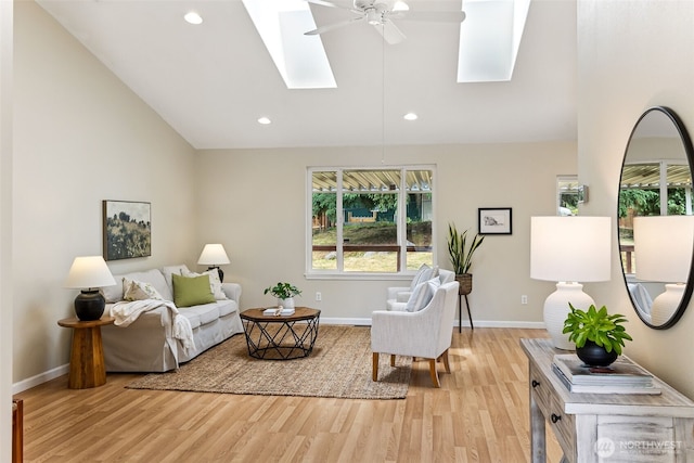 8537 Thuja Ave SE, Yelm, WA 98597 - living area featuring a skylight, lofted ceiling, healthy amount of natural light, light wood-type flooring, and ceiling fan