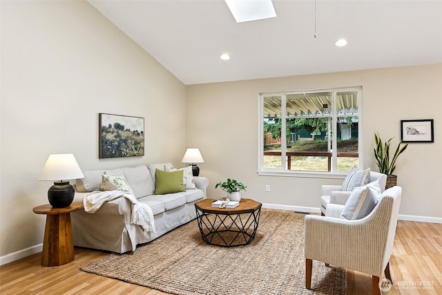 8537 Thuja Ave SE, Yelm, WA 98597 - living area featuring wood finished floors, a skylight, vaulted ceiling, and recessed lighting