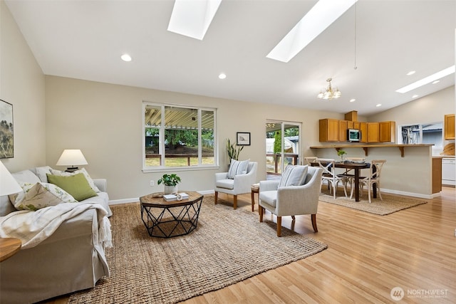 8537 Thuja Ave SE, Yelm, WA 98597 - living area with a skylight, a chandelier, light wood finished floors, vaulted ceiling, and recessed lighting