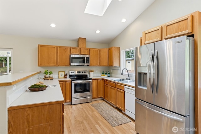 8537 Thuja Ave SE, Yelm, WA 98597 - kitchen with appliances with stainless steel finishes, plenty of natural light, lofted ceiling, light countertops, and a skylight