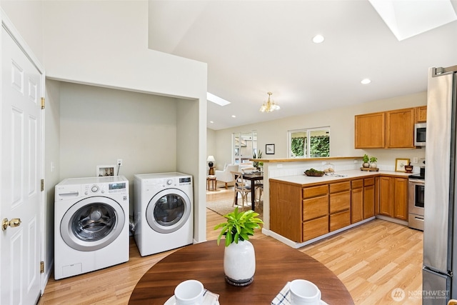 8537 Thuja Ave SE, Yelm, WA 98597 - washroom featuring separate washer and dryer, a skylight, light wood-style floors, a chandelier, and recessed lighting