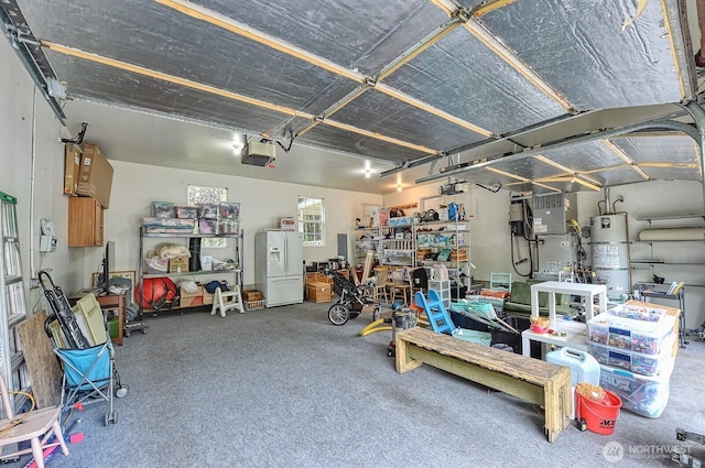 5679 W 31st Crst, Ferndale, WA 98248 - garage featuring secured water heater, a garage door opener, and white refrigerator with ice dispenser