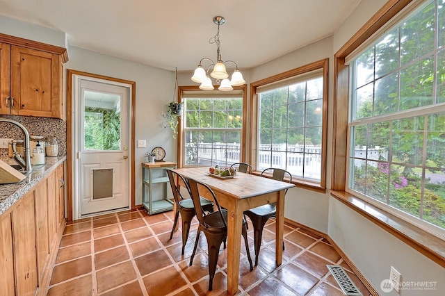 5679 W 31st Crst, Ferndale, WA 98248 - dining room featuring a chandelier, healthy amount of natural light, and light tile patterned floors