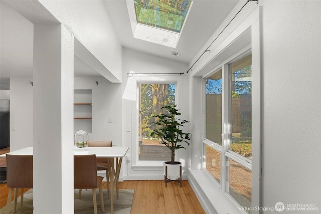 10746 Densmore Ave N, Seattle, WA 98133 - dining space featuring wood finished floors, vaulted ceiling, healthy amount of natural light, and a skylight