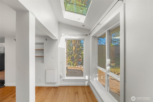 10746 Densmore Ave N, Seattle, WA 98133 - foyer with wood finished floors, vaulted ceiling, plenty of natural light, and a skylight