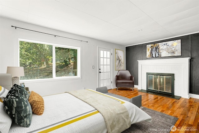 10746 Densmore Ave N, Seattle, WA 98133 - bedroom with wood finished floors and a brick fireplace