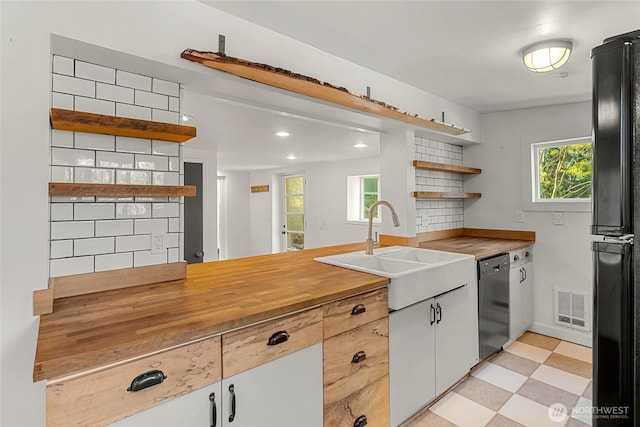 10746 Densmore Ave N, Seattle, WA 98133 - kitchen featuring open shelves, dishwasher, freestanding refrigerator, decorative backsplash, and light floors