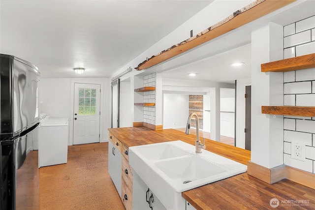 10746 Densmore Ave N, Seattle, WA 98133 - kitchen featuring open shelves, freestanding refrigerator, wood counters, washer / clothes dryer, and light flooring