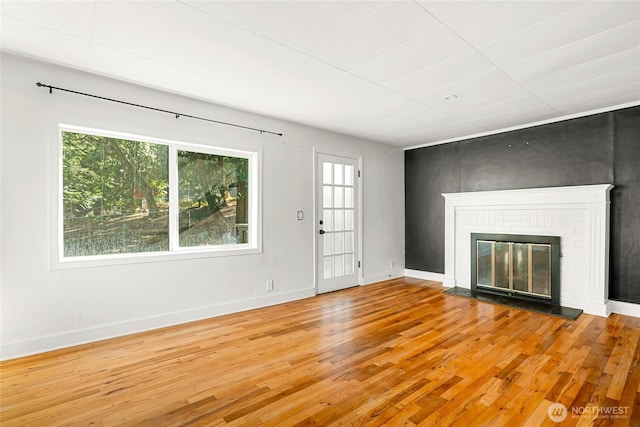 10746 Densmore Ave N, Seattle, WA 98133 - unfurnished living room with wood finished floors and a brick fireplace