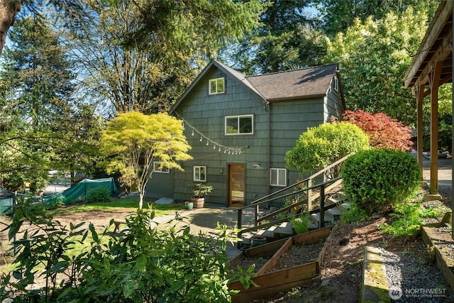 10746 Densmore Ave N, Seattle, WA 98133 - rear view of house with a shingled roof and a patio area