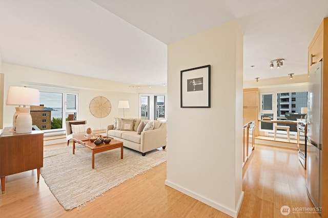 121 Vine St Unit 703, Seattle, WA 98121 - living area with light wood-type flooring, plenty of natural light, and an office area