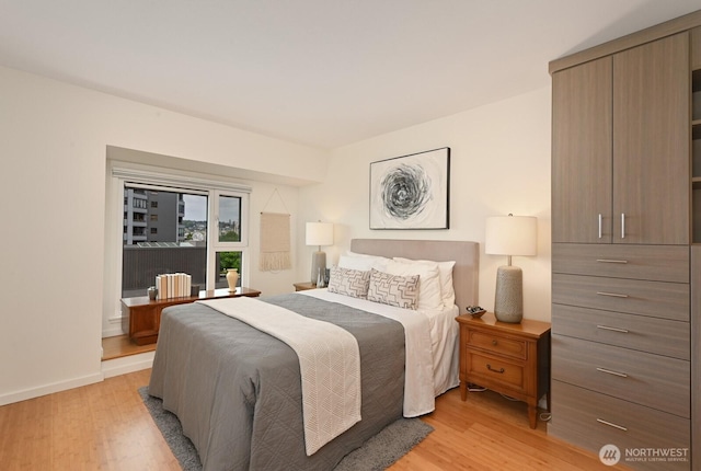 121 Vine St Unit 703, Seattle, WA 98121 - bedroom with light wood-style flooring and baseboards