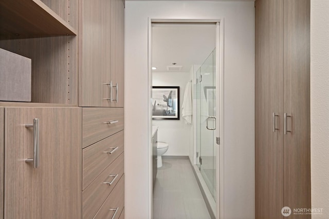 121 Vine St Unit 703, Seattle, WA 98121 - bathroom featuring toilet and a shower stall