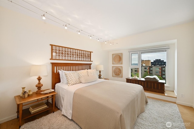121 Vine St Unit 703, Seattle, WA 98121 - bedroom featuring rail lighting and light wood finished floors