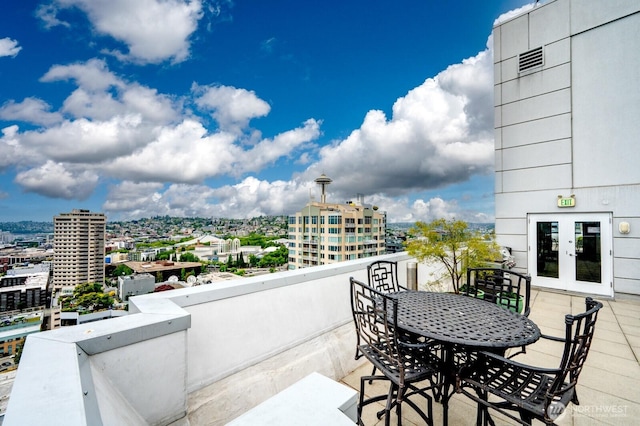 121 Vine St Unit 703, Seattle, WA 98121 - balcony featuring french doors, a view of city, and outdoor dining area