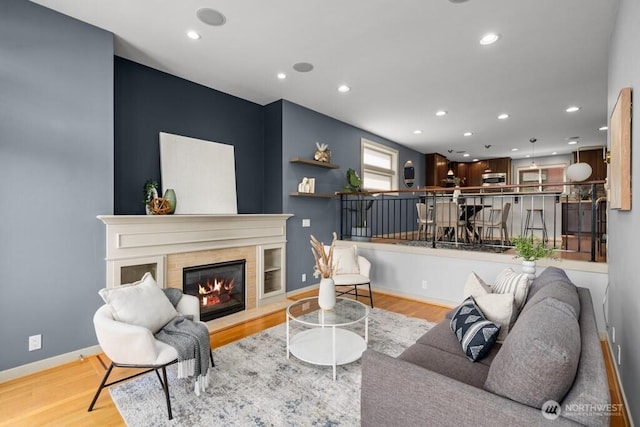 7747 Sand Point Way NE Unit A, Seattle, WA 98115 - living area featuring wood finished floors, recessed lighting, and a glass covered fireplace