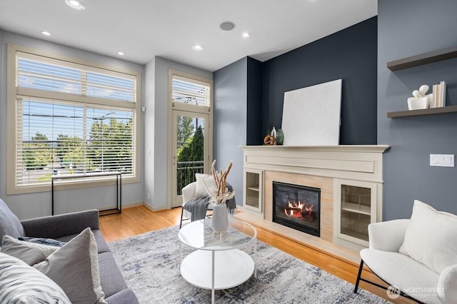 7747 Sand Point Way NE Unit A, Seattle, WA 98115 - living room featuring wood finished floors, a glass covered fireplace, and recessed lighting