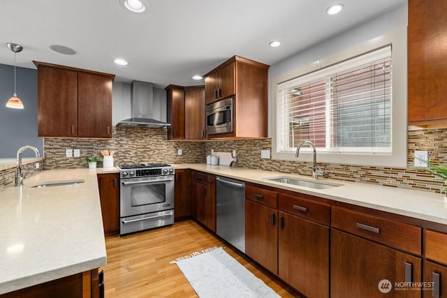 7747 Sand Point Way NE Unit A, Seattle, WA 98115 - kitchen with appliances with stainless steel finishes, wall chimney exhaust hood, light wood-style floors, light countertops, and recessed lighting