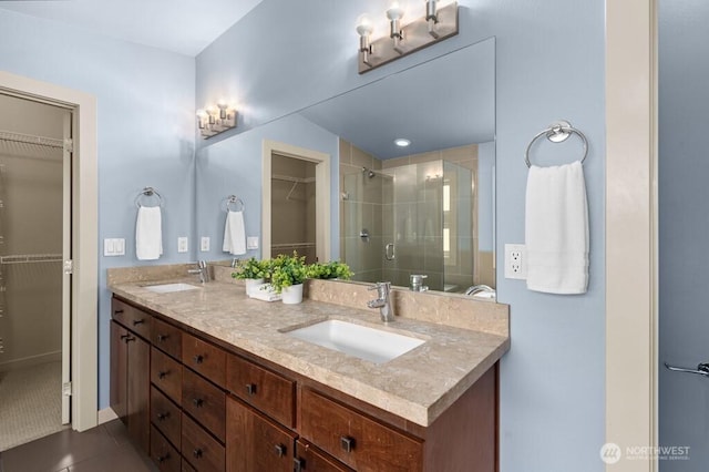 7747 Sand Point Way NE Unit A, Seattle, WA 98115 - bathroom featuring double vanity, a walk in closet, a stall shower, and tile patterned flooring