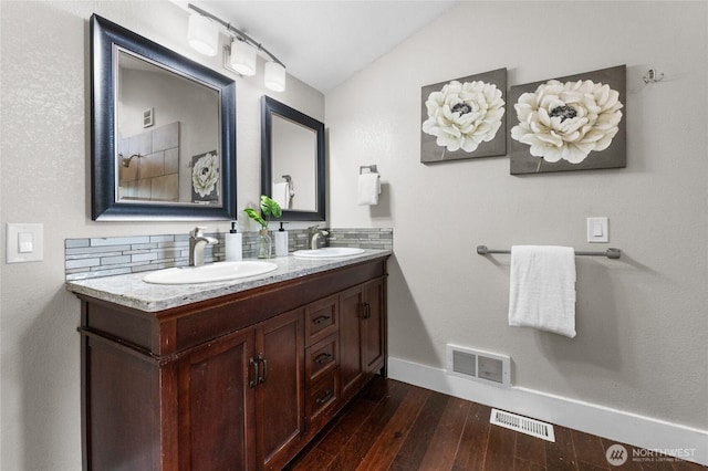 12712 232nd Ave E, Buckley, WA 98321 - bathroom with double vanity, hardwood / wood-style floors, and vaulted ceiling