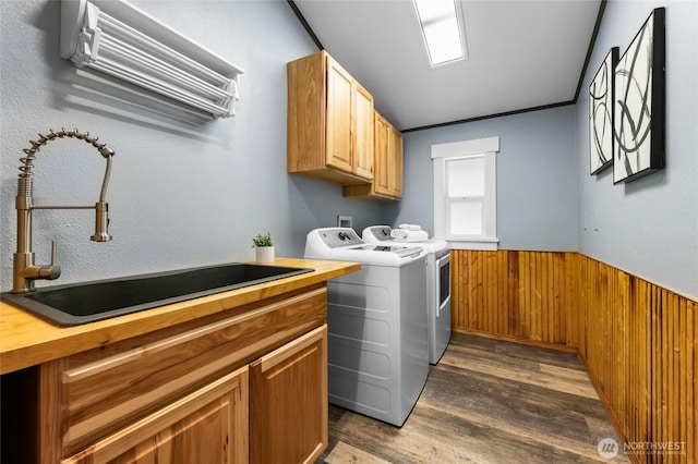12712 232nd Ave E, Buckley, WA 98321 - laundry area featuring separate washer and dryer, cabinet space, dark wood-style flooring, a wainscoted wall, and wooden walls