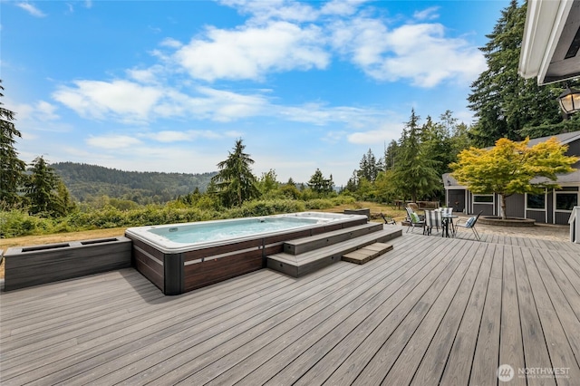 12712 232nd Ave E, Buckley, WA 98321 - wooden deck with an outdoor hot tub, a wooded view, and outdoor dining space