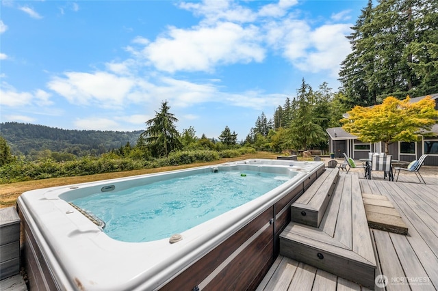 12712 232nd Ave E, Buckley, WA 98321 - view of swimming pool with a wooden deck and a wooded view
