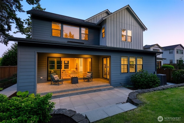 8784 NE Winslow Grove Ct, Bainbridge Island, WA 98110 - back of house with board and batten siding, a patio area, and an outdoor hangout area