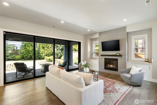 8784 NE Winslow Grove Ct, Bainbridge Island, WA 98110 - living area with plenty of natural light, wood finished floors, recessed lighting, and a tiled fireplace