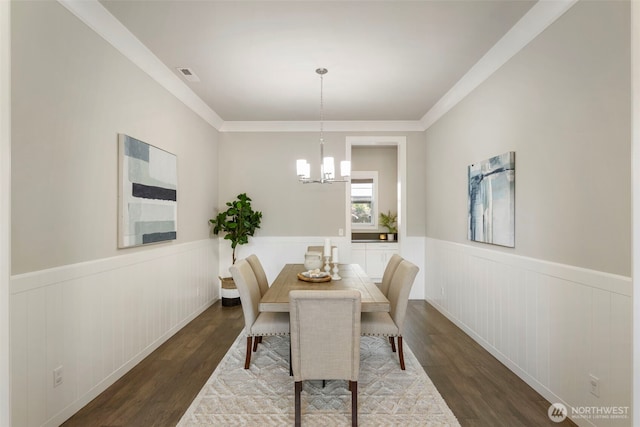 8784 NE Winslow Grove Ct, Bainbridge Island, WA 98110 - dining area with a wainscoted wall, wood finished floors, a chandelier, and crown molding