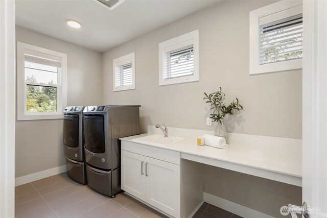 8784 NE Winslow Grove Ct, Bainbridge Island, WA 98110 - laundry area featuring washer and dryer, cabinet space, and light tile patterned floors