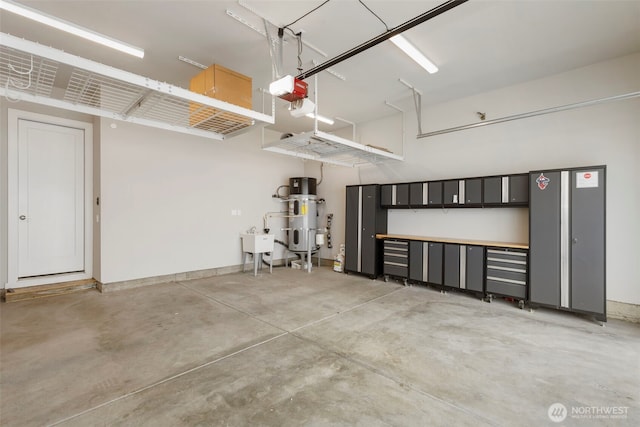 8784 NE Winslow Grove Ct, Bainbridge Island, WA 98110 - garage featuring a garage door opener and heat pump water heater