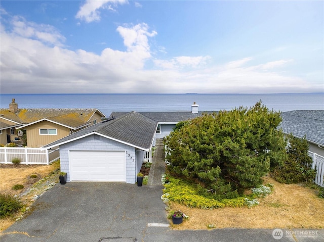 1523 N Whitecap Ln, Oak Harbor, WA 98277 - view of front of property featuring asphalt driveway, an attached garage, roof with shingles, and a water view