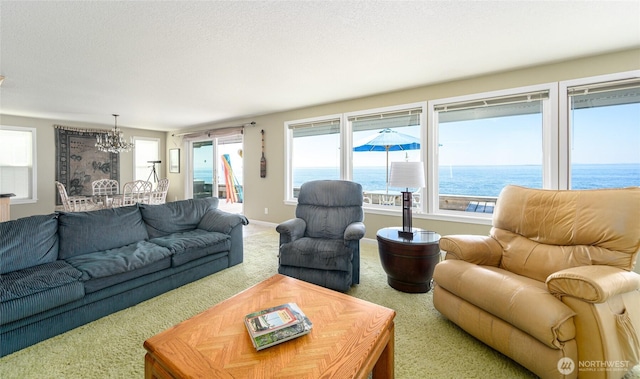 1523 N Whitecap Ln, Oak Harbor, WA 98277 - carpeted living area with a chandelier and a water view
