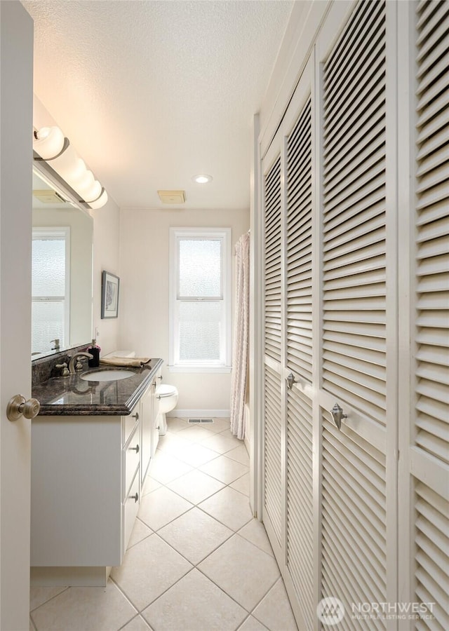 1523 N Whitecap Ln, Oak Harbor, WA 98277 - full bath with a closet, vanity, tile patterned floors, a textured ceiling, and curtained shower