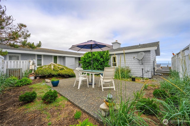 1523 N Whitecap Ln, Oak Harbor, WA 98277 - back of property with a patio area, a chimney, and a shingled roof
