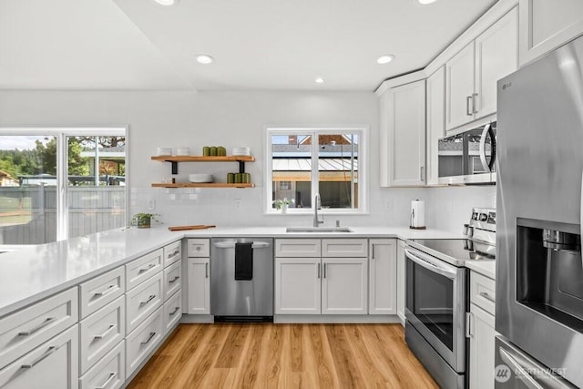 491 Pebble Beach Dr, Cle Elum, WA 98922 - kitchen with appliances with stainless steel finishes, plenty of natural light, light wood finished floors, light countertops, and recessed lighting