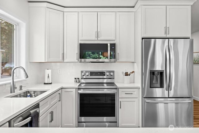 491 Pebble Beach Dr, Cle Elum, WA 98922 - kitchen featuring stainless steel appliances, tasteful backsplash, white cabinets, and light countertops