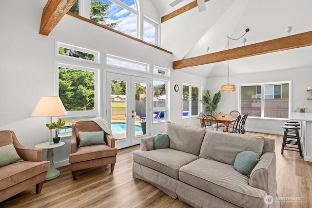 491 Pebble Beach Dr, Cle Elum, WA 98922 - living area featuring beam ceiling, high vaulted ceiling, french doors, and light wood-style flooring
