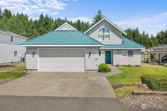 491 Pebble Beach Dr, Cle Elum, WA 98922 - view of front of home with a standing seam roof, a metal roof, a front lawn, concrete driveway, and a garage